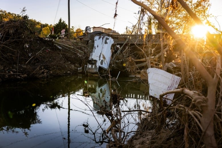 A van and other debris after a hurricane.