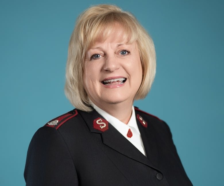 A woman with a blond bob wearing a dark jacket.