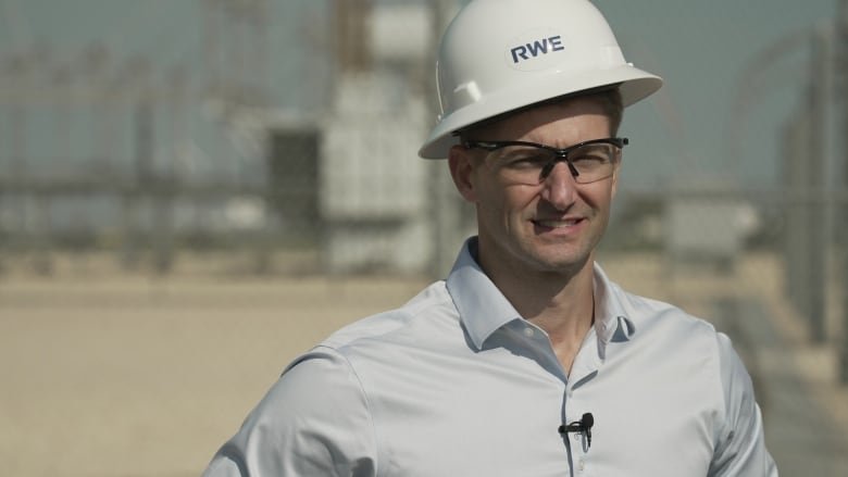 Tim Nelson, SVP of operations at German energy giant RWE stands in front of a storage site in Texas. He says battery storage technology is key to meeting growing energy demands.