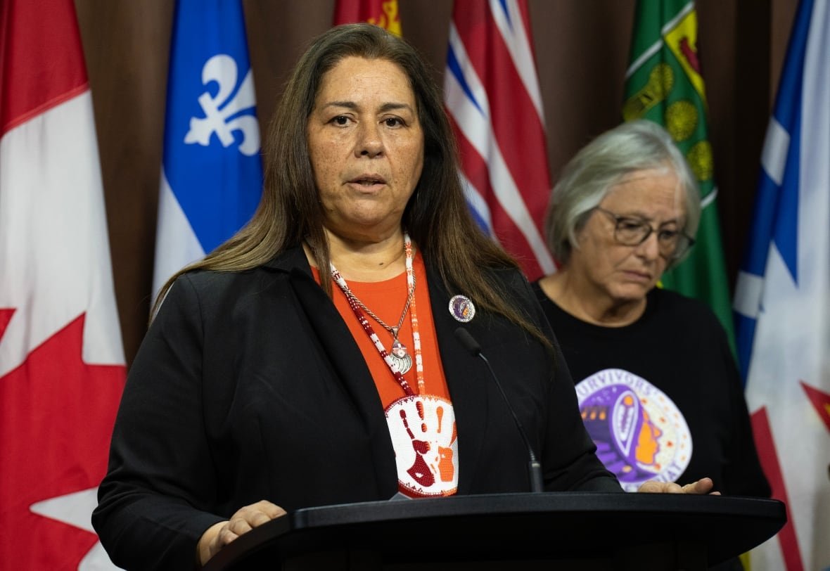 Survivor of the Mohawk Institute and board member of The Survivors’ Secretariat Roberta Hill, right, looks on as Secretariat Executive Lead Laura Arndt speaks during a news conference on Parliament Hill, in Ottawa, Monday, Sept. 30, 2024.