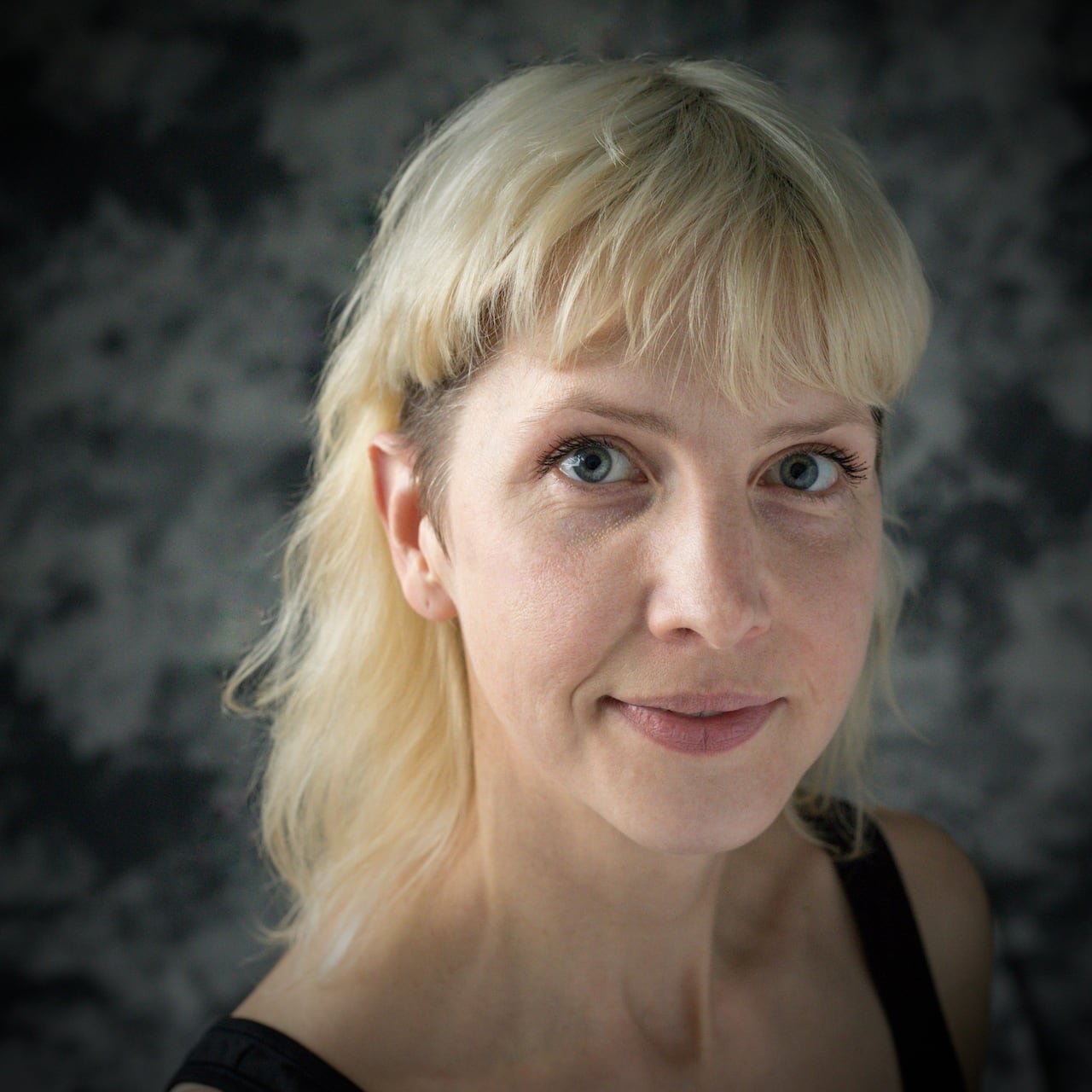 default-316 A woman with blonde hair looks at the camera.